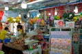 Expat and local shoppers browsing at a sundry and fruit stall in a `heartland` neighborhood of Singapore